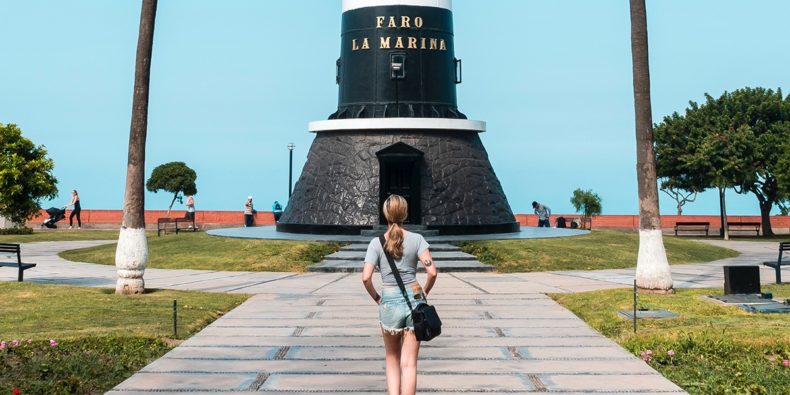 woman walking to the lighthouse traveling peru alone